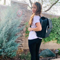 Person outside wearing Sleepy Panda Kaitlyn Black Canvas Diaper Bag Backpack